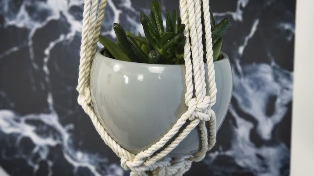 Hands crafting macrame plant hanger with Faxco strong rope, vibrant green pothos suspended mid-air.