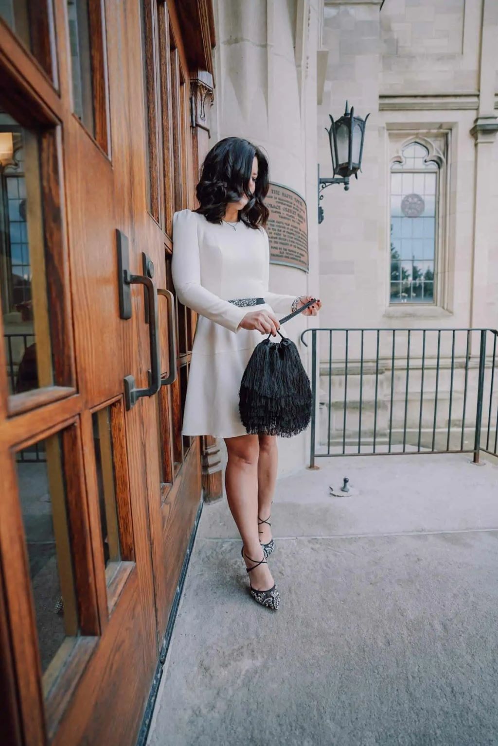 Fashion flat lay featuring a dusty blue dress paired with beige heels, silver jewelry, and a cream handbag