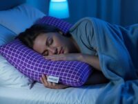 Side sleeper resting peacefully on Purple Harmony Anywhere Pillow with visible purple grid and cool blue tones