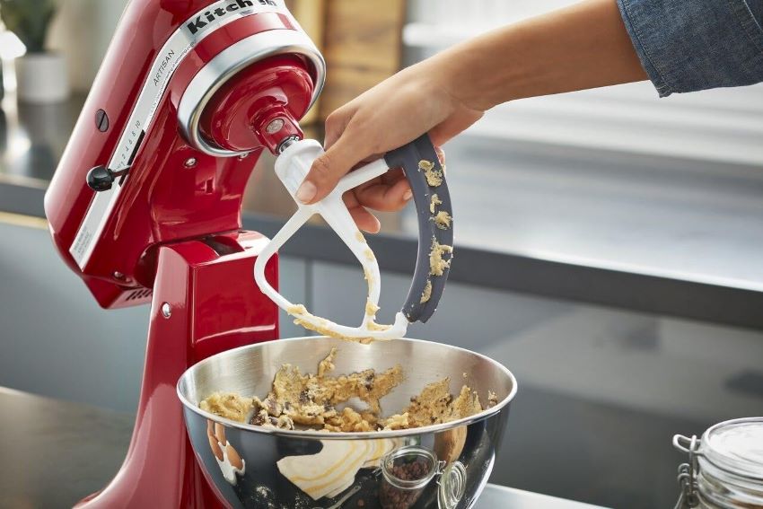KitchenAid KFE5T Flex Edge Beater attached to a stand mixer for baking.