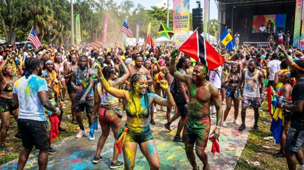 Revelers covered in paint and powder dancing through Central Broward Park at J'ouvert during Miami Broward Carnival 2026 in Lauderhill, Florida